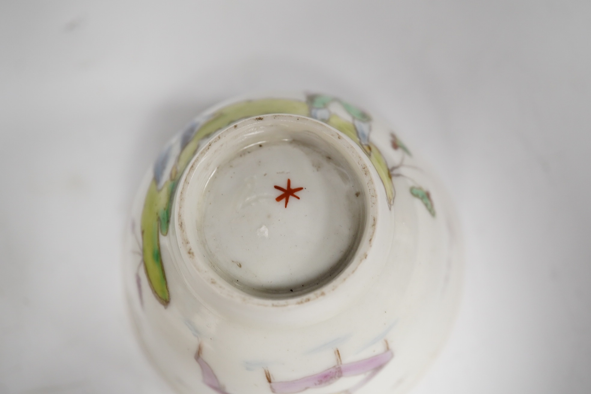 A Nove porcelain tea bowl and saucer, c.1770-75, hand painted with Chinese figures, iron red asterisk marks, 11.5cm in diameter